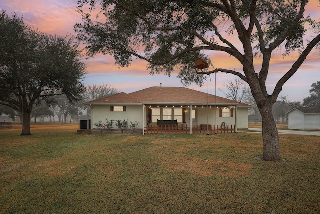 ranch-style home with a lawn