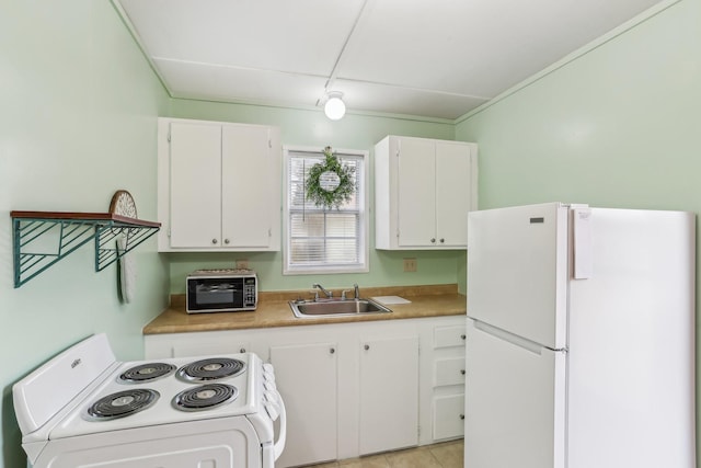 kitchen featuring white appliances, sink, and white cabinets