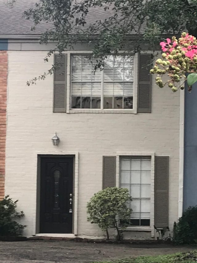 entrance to property featuring brick siding