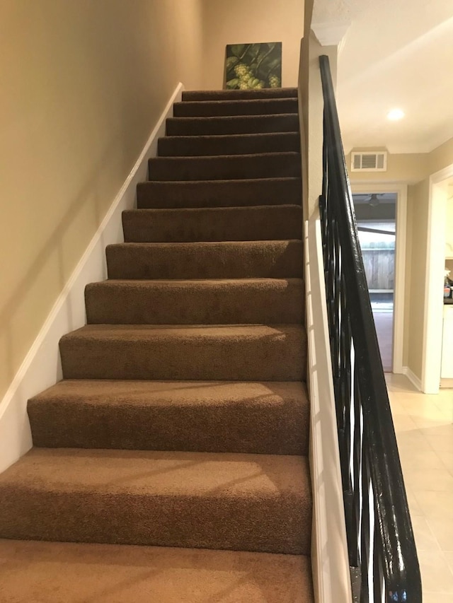 stairway with visible vents, tile patterned flooring, and recessed lighting