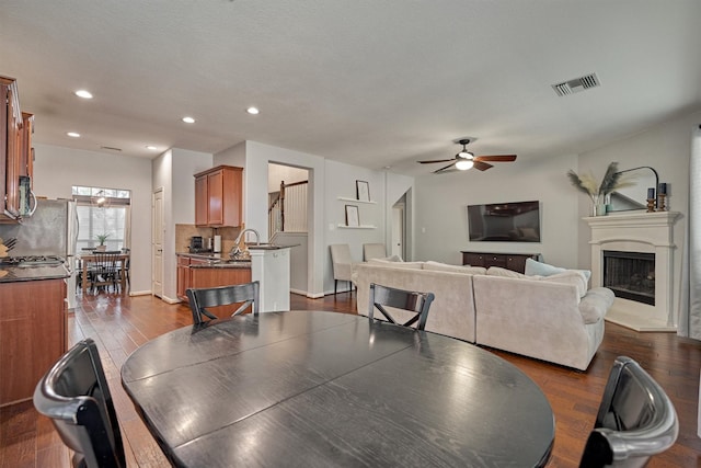 dining space with dark hardwood / wood-style flooring and ceiling fan