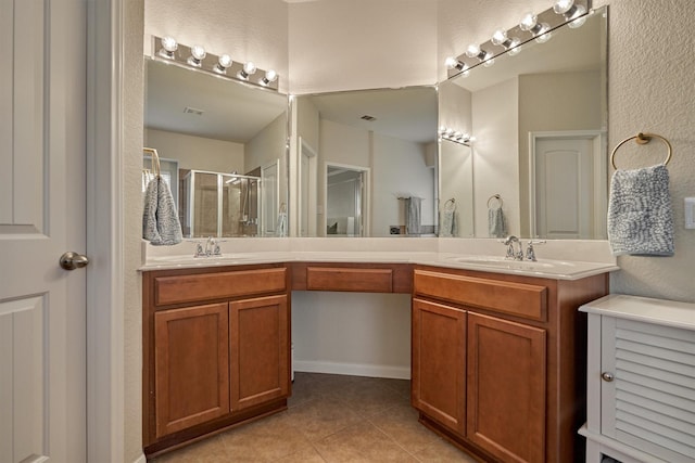 bathroom featuring vanity, tile patterned flooring, and a shower with shower door