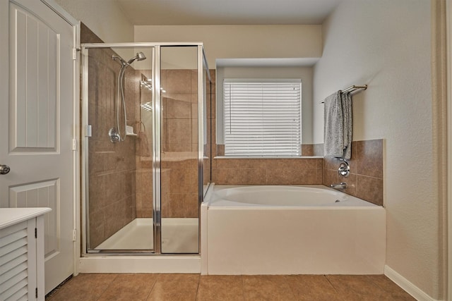 bathroom with independent shower and bath and tile patterned floors