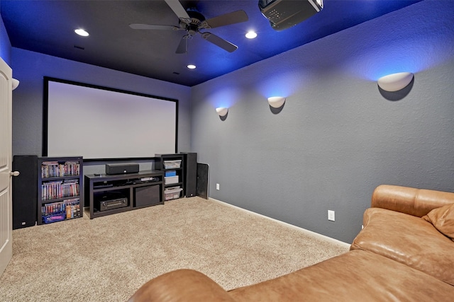 carpeted cinema room with ceiling fan