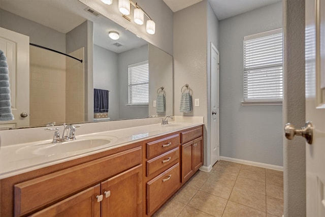 bathroom with vanity, plenty of natural light, and tile patterned floors