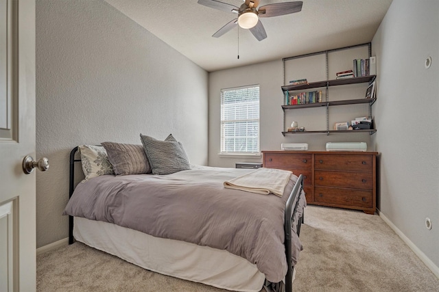 bedroom with light colored carpet and ceiling fan