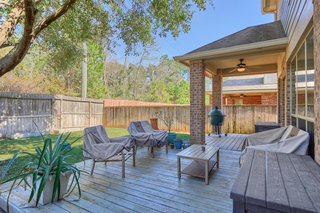 wooden terrace with grilling area and ceiling fan