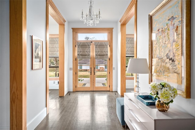 doorway with dark hardwood / wood-style flooring, french doors, and a chandelier