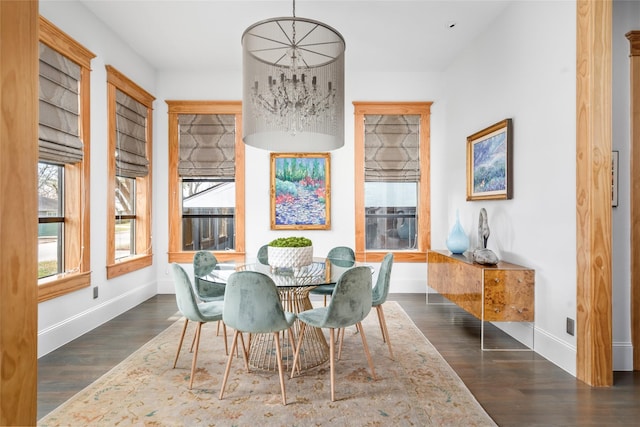 dining space featuring an inviting chandelier and dark hardwood / wood-style flooring