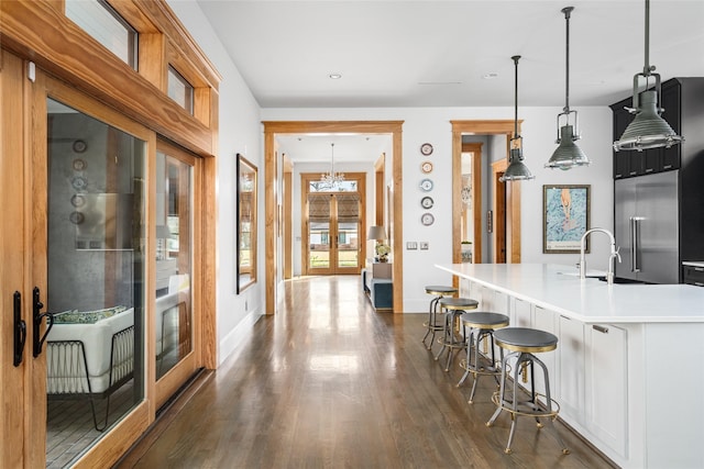 kitchen with french doors, sink, decorative light fixtures, and built in fridge