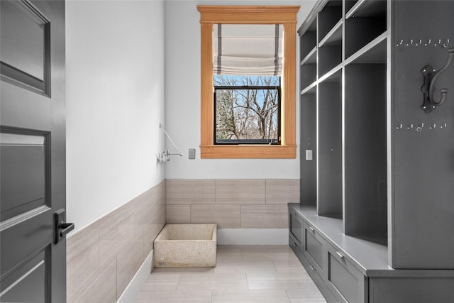 mudroom featuring tile walls