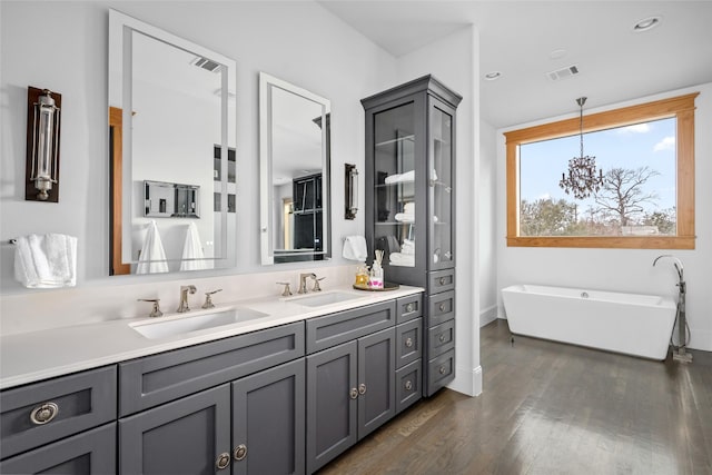 bathroom featuring vanity, a tub, and hardwood / wood-style floors