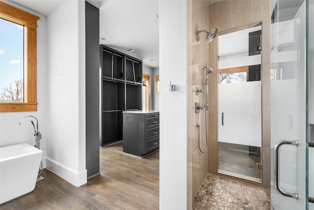 bathroom featuring vanity, independent shower and bath, and hardwood / wood-style floors