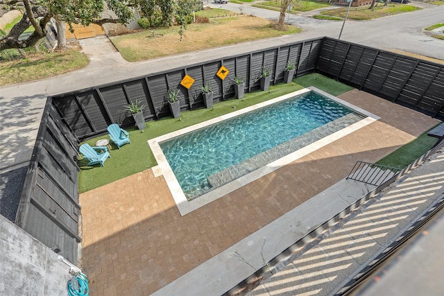 view of swimming pool with a patio area