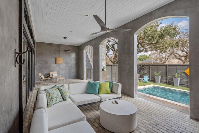 view of patio / terrace featuring an outdoor living space, a fenced in pool, and ceiling fan