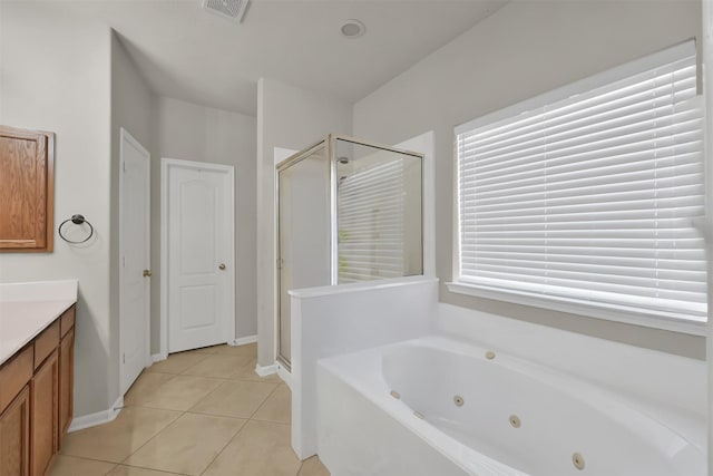 bathroom with independent shower and bath, vanity, and tile patterned flooring