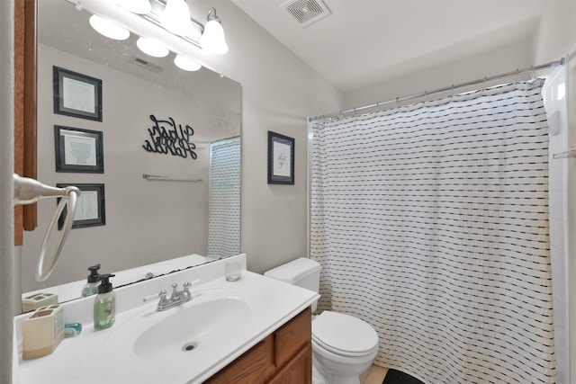 bathroom featuring vanity, curtained shower, and toilet