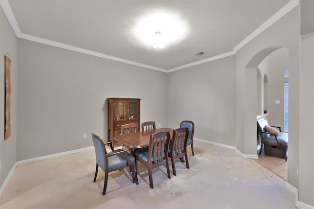 dining space featuring crown molding