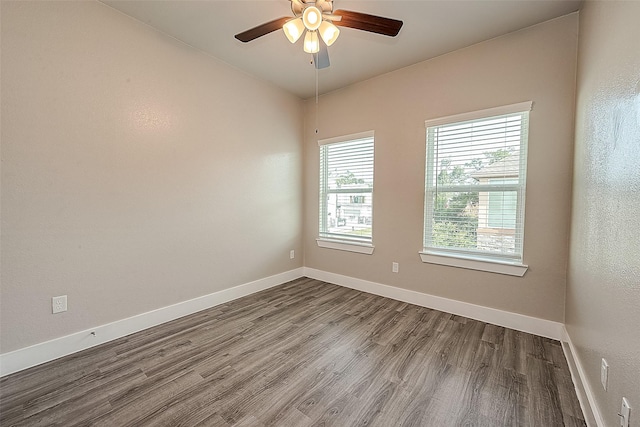 spare room with hardwood / wood-style flooring and ceiling fan