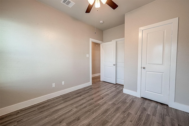 unfurnished bedroom featuring ceiling fan and dark hardwood / wood-style floors