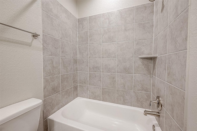 bathroom with toilet and tiled shower / bath combo