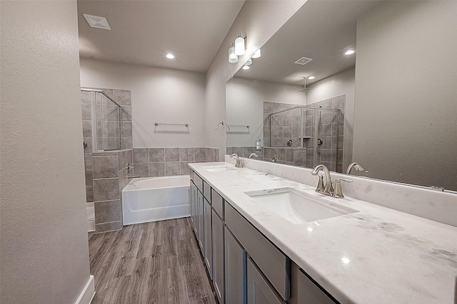 bathroom with vanity, hardwood / wood-style floors, and independent shower and bath