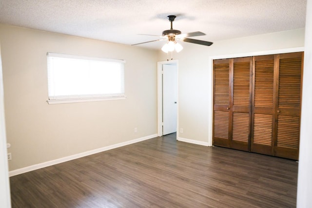 unfurnished bedroom featuring dark hardwood / wood-style flooring, a closet, and a textured ceiling