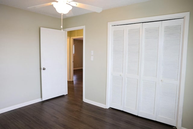 unfurnished bedroom featuring a closet, dark hardwood / wood-style floors, and ceiling fan