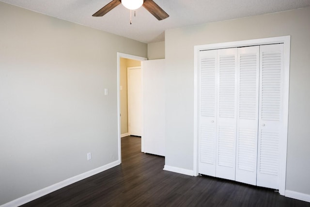 unfurnished bedroom with ceiling fan, dark hardwood / wood-style floors, and a closet