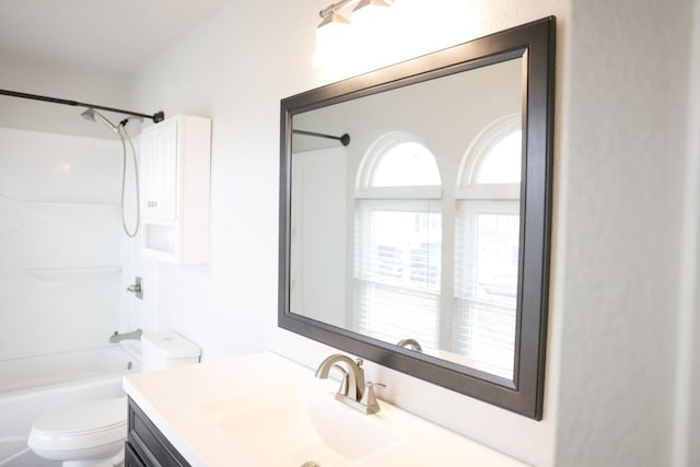 full bathroom featuring vanity, bathtub / shower combination, and toilet