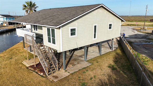 rear view of property featuring a yard and a water view