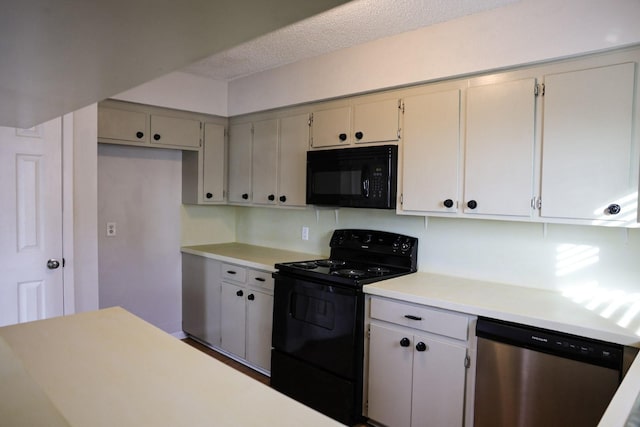 kitchen featuring a textured ceiling and black appliances