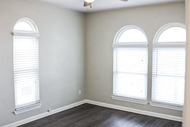 spare room featuring ceiling fan, a textured ceiling, and dark hardwood / wood-style flooring