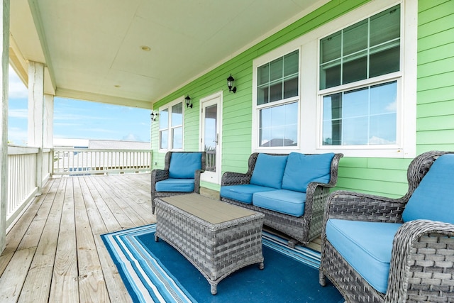 wooden terrace with a porch and an outdoor hangout area