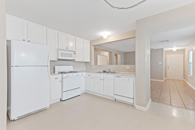 kitchen with sink, white appliances, and white cabinets