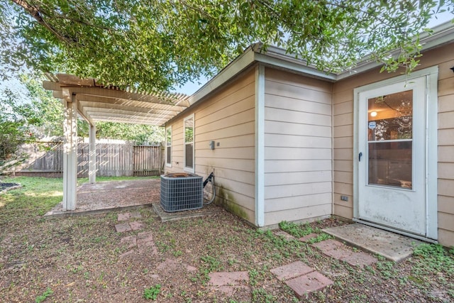 exterior space with central AC and a pergola