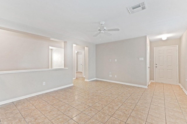 tiled spare room with ceiling fan