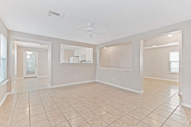 spare room featuring ceiling fan and light tile patterned flooring