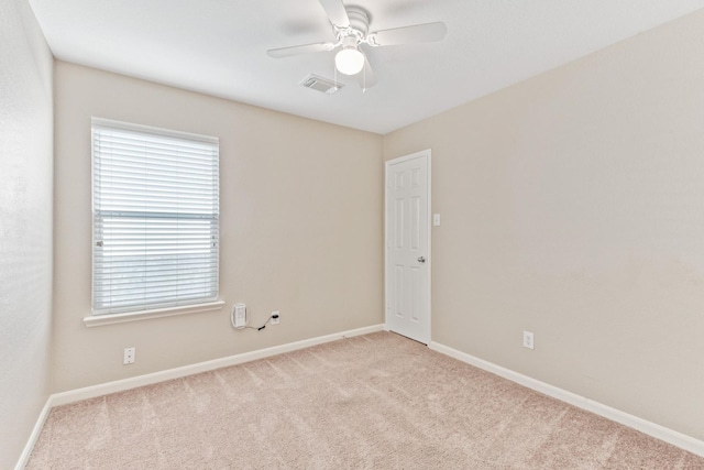 spare room with light carpet and ceiling fan