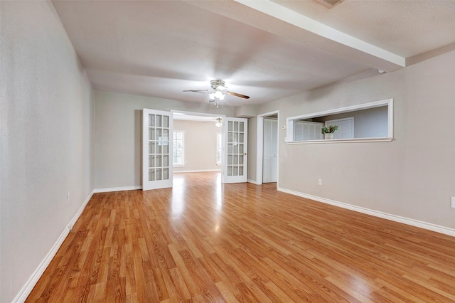 unfurnished room with french doors, ceiling fan, and light hardwood / wood-style flooring