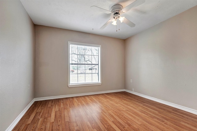 spare room with light hardwood / wood-style flooring and ceiling fan