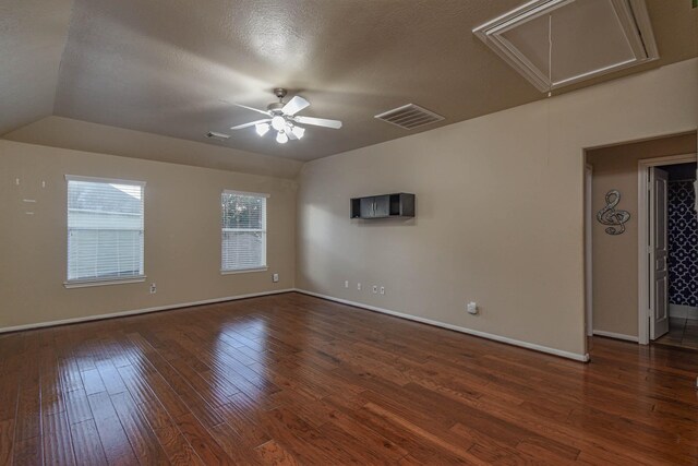 empty room featuring dark wood-type flooring, ceiling fan, and a textured ceiling