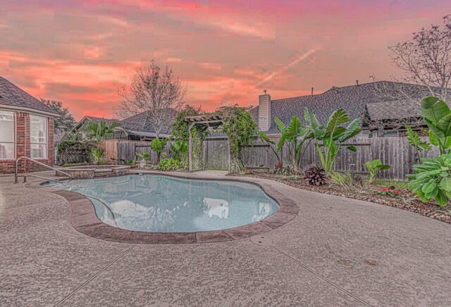 pool at dusk with a patio