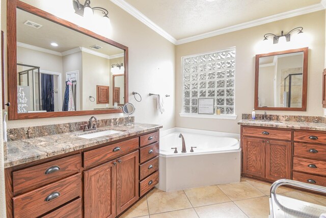 bathroom featuring vanity, tile patterned flooring, ornamental molding, and a bathing tub