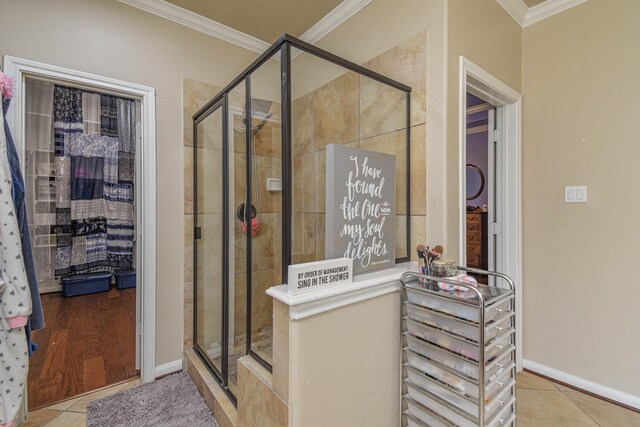 bathroom featuring tile patterned flooring, crown molding, and walk in shower