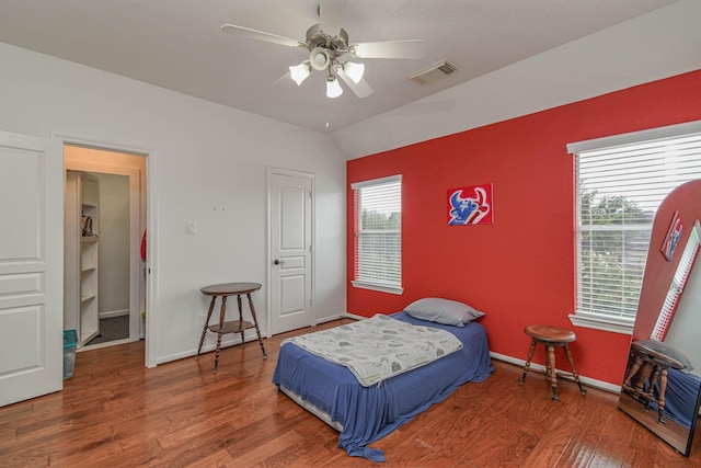 bedroom featuring lofted ceiling, wood-type flooring, and ceiling fan