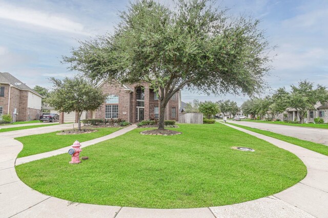 view of home's community with a lawn