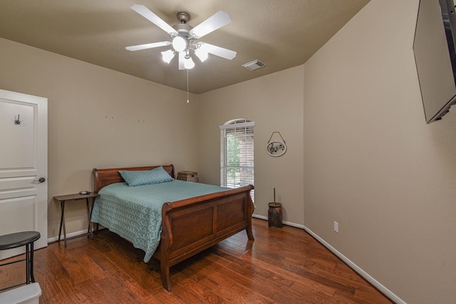 bedroom with dark hardwood / wood-style flooring and ceiling fan