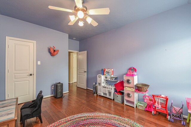 office space featuring dark wood-type flooring and ceiling fan