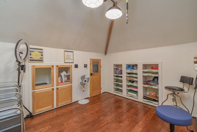 interior space featuring vaulted ceiling with beams and dark hardwood / wood-style flooring